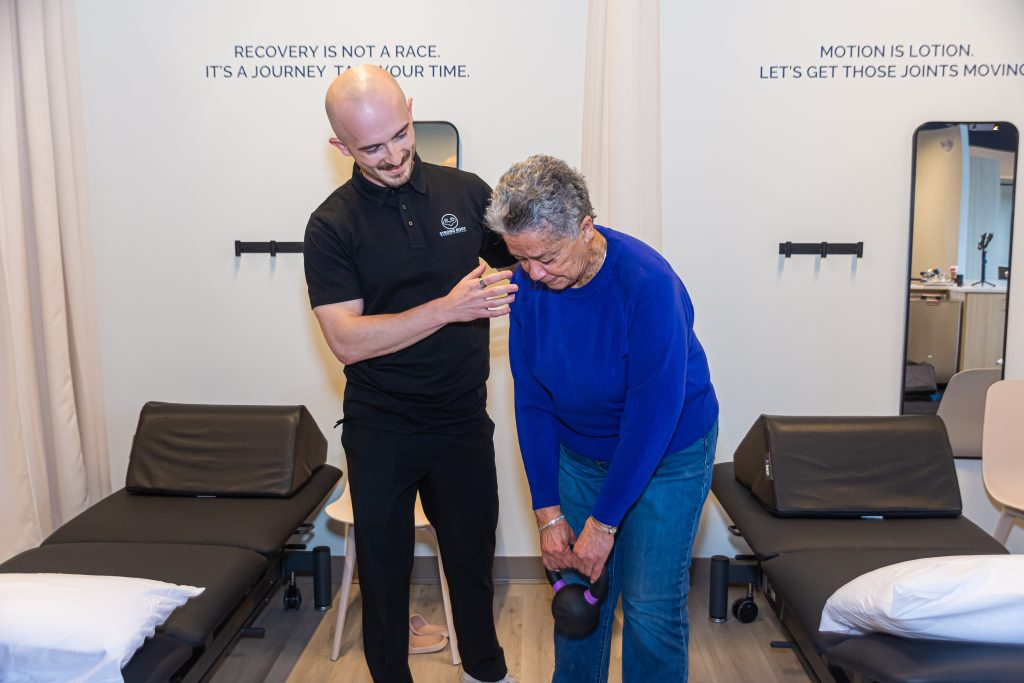 Therapist guiding woman during rehab session